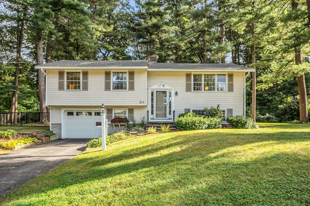 a view of a house with a yard and sitting area