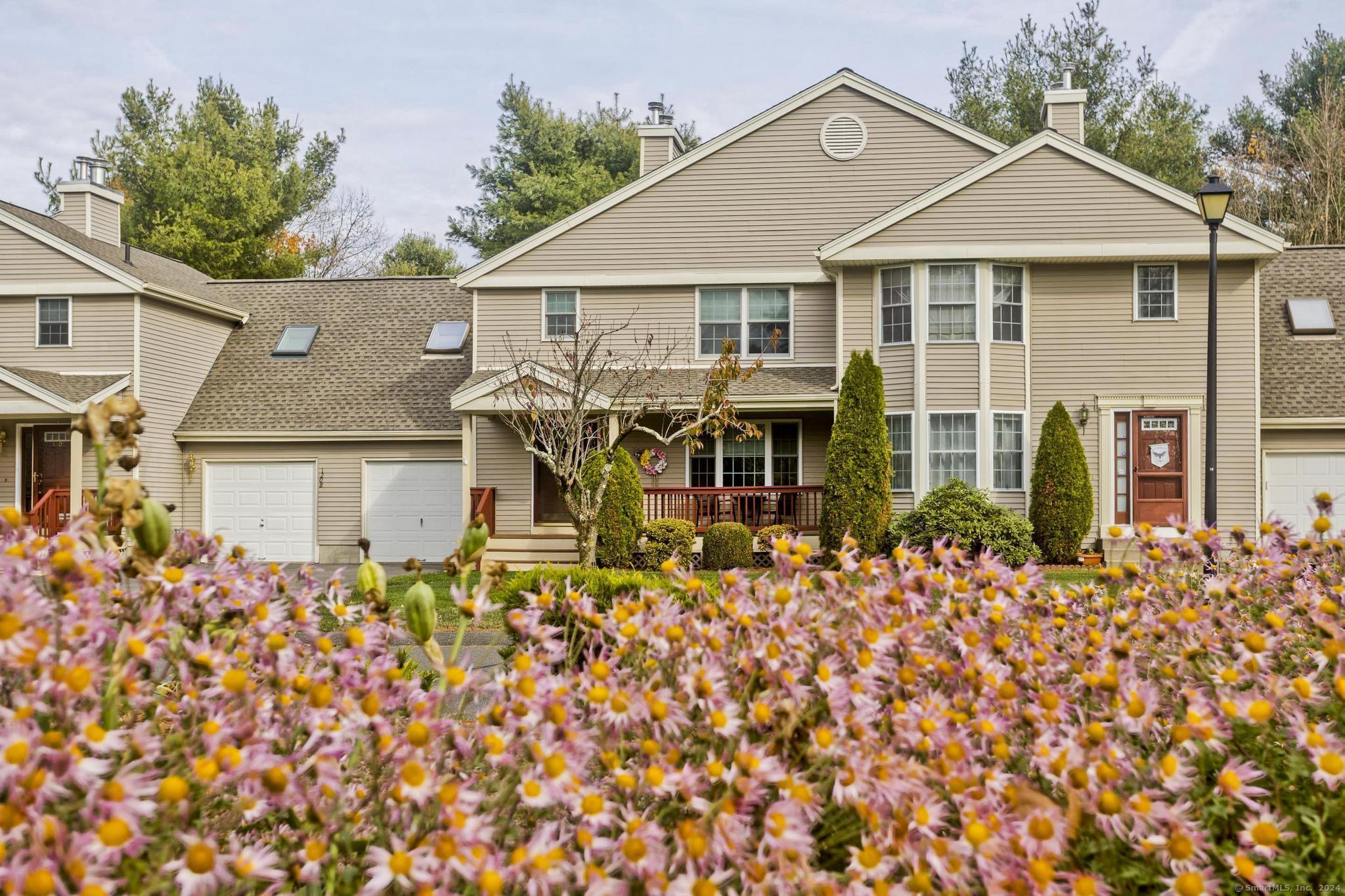 a front view of a house with garden