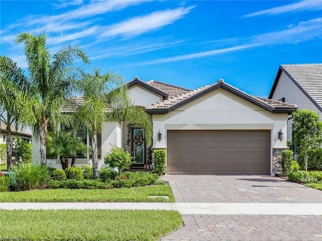 a front view of a house with a yard and garage