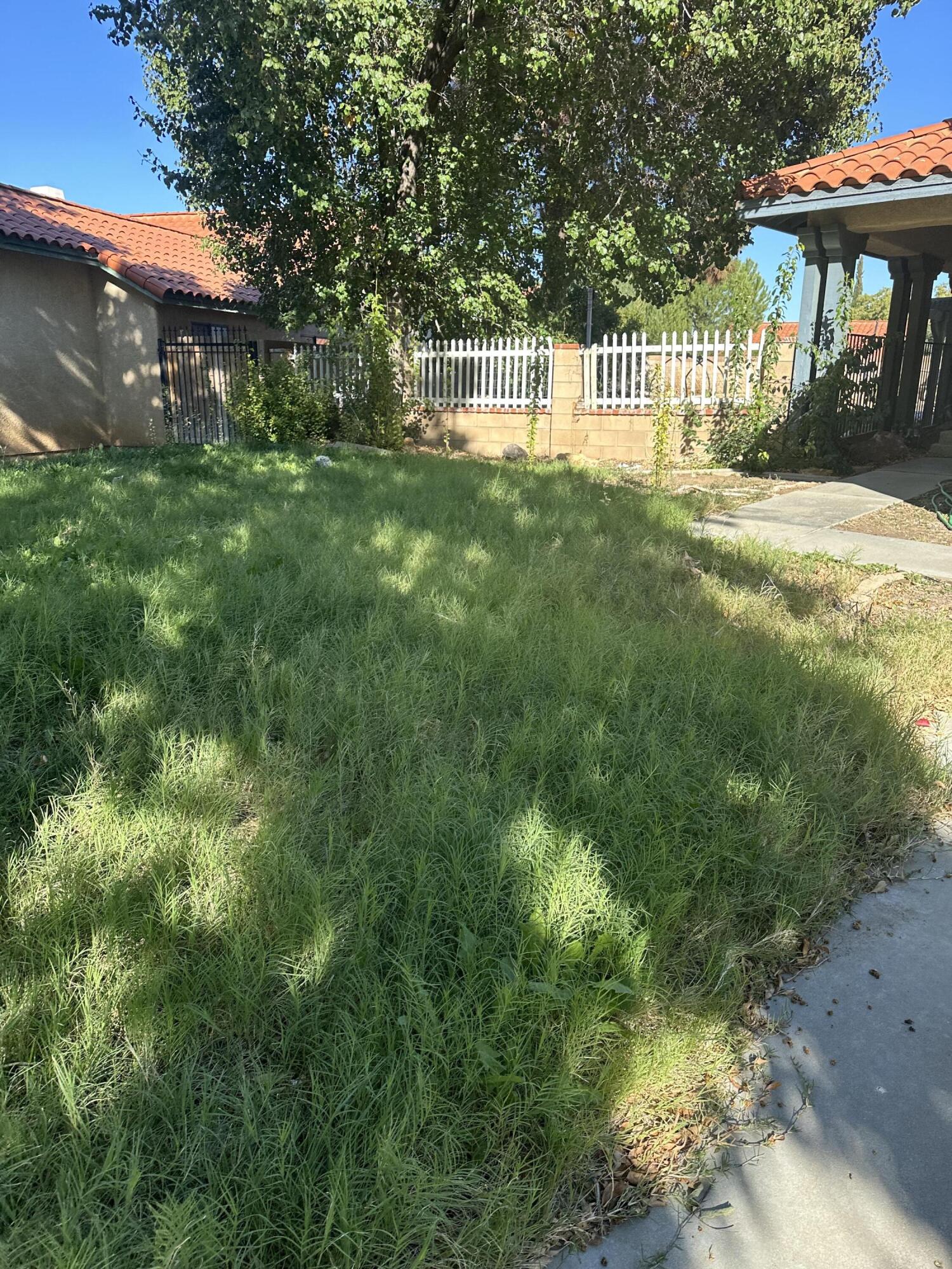 a view of a house with a yard and sitting area