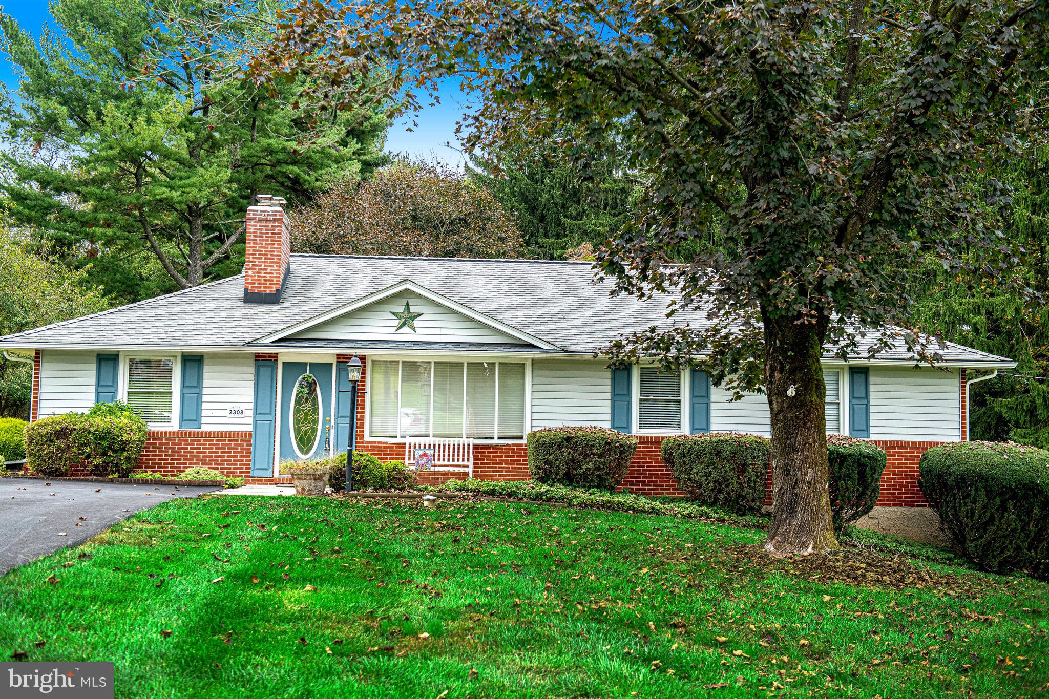 a front view of house with yard and green space