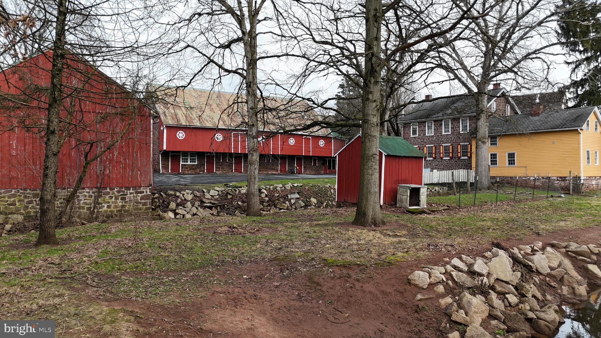 a view of a house with a yard and trees