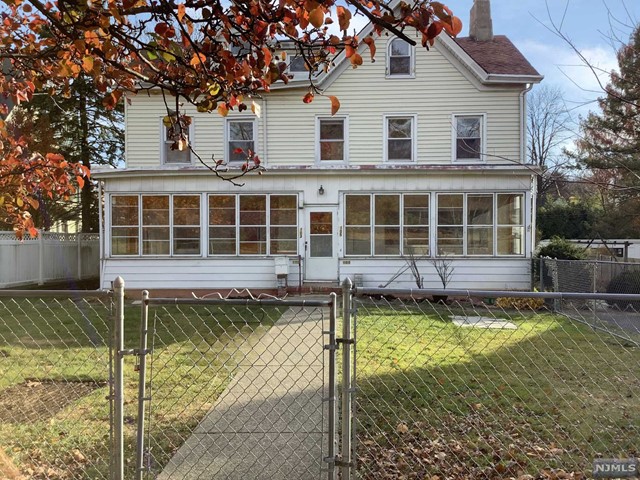 a front view of a house with a yard table and chairs