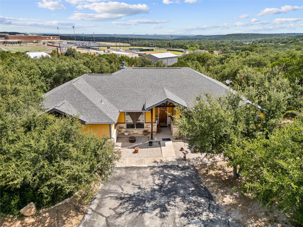 an aerial view of a house with a garden and lake view