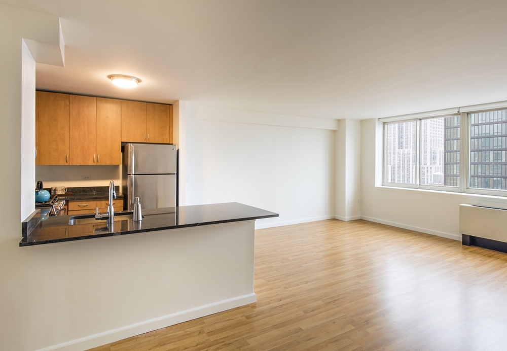 a view of a room with wooden floor and a window