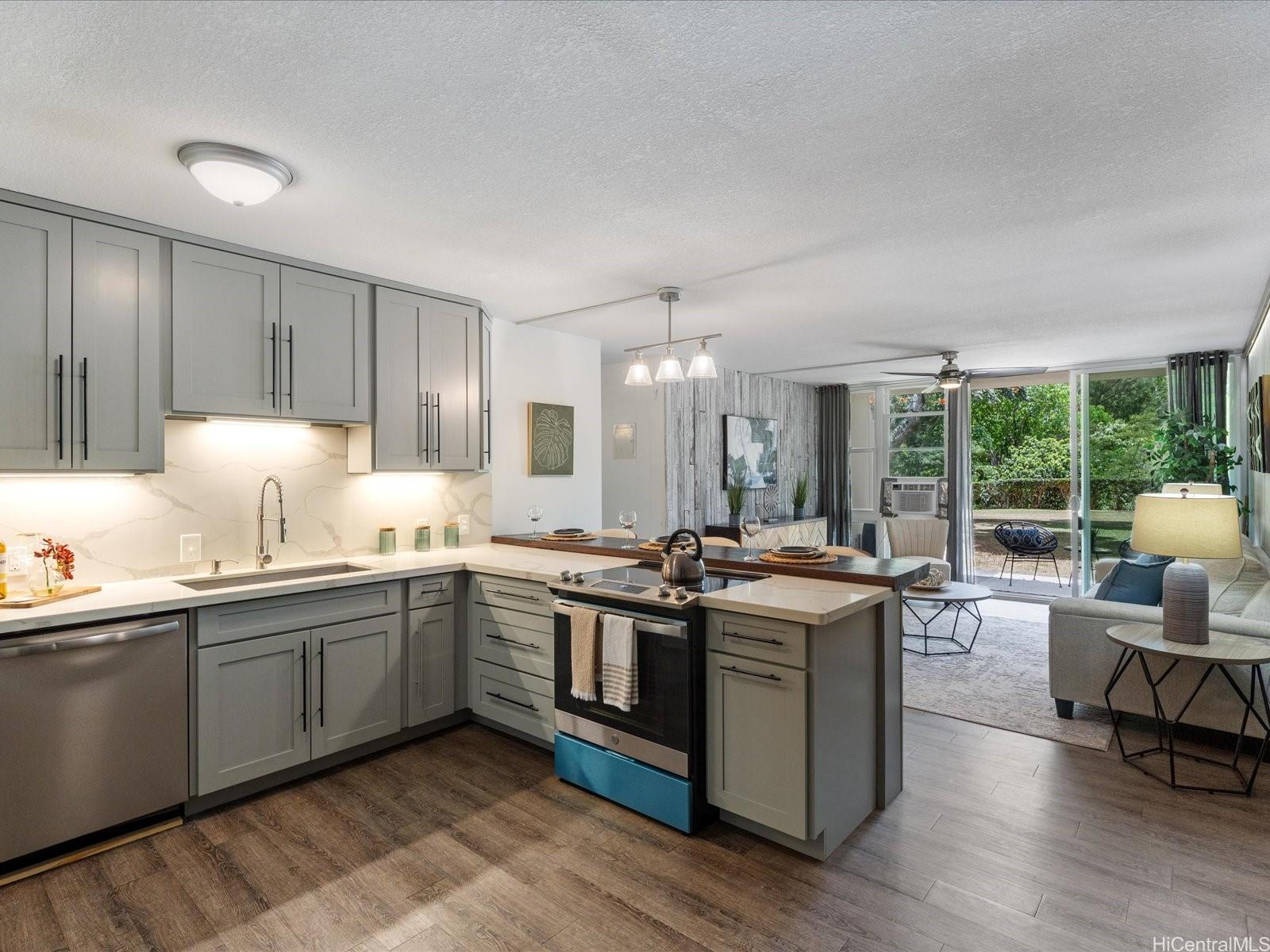 a open kitchen with stainless steel appliances granite countertop a stove and a sink