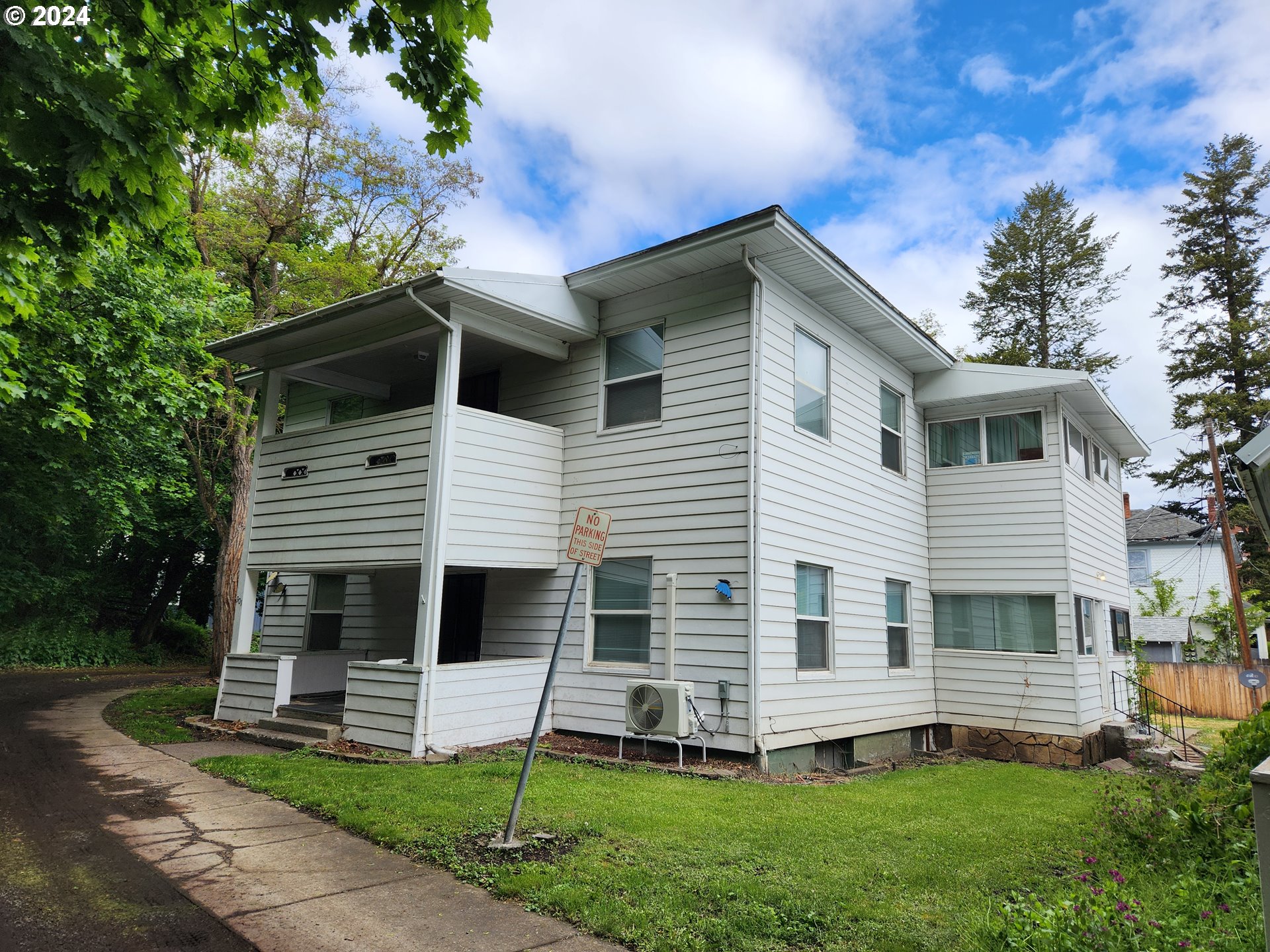 a front view of a house with a yard and porch