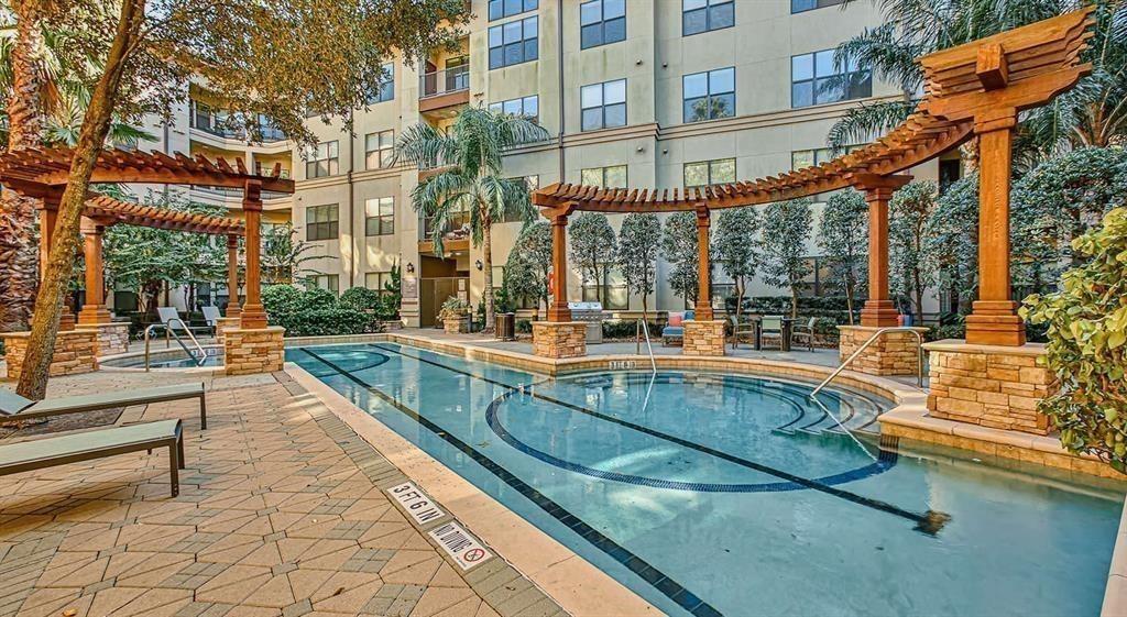 a view of swimming pool with outdoor seating and a pathway