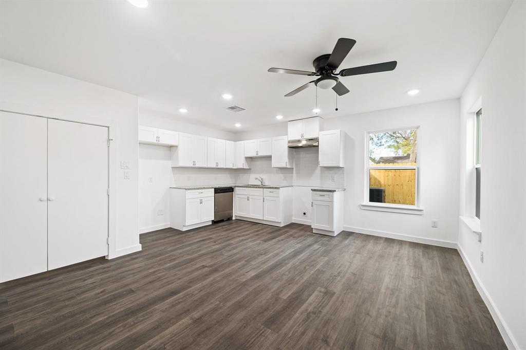 a view of a kitchen with a sink and a window