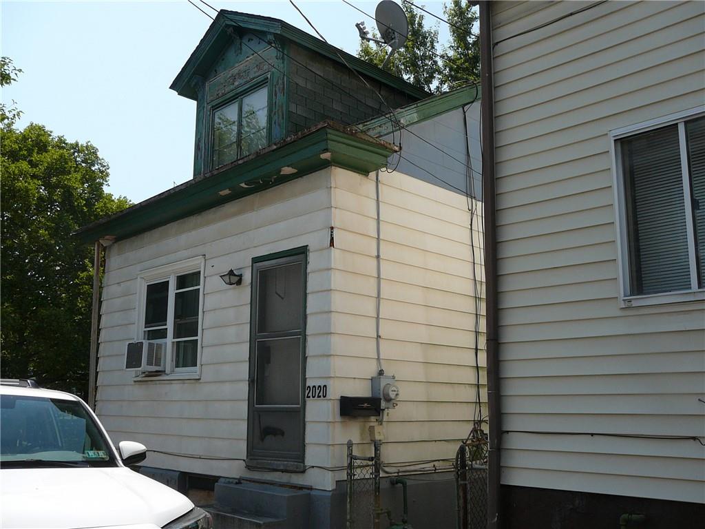 a view of residential house with stairs and wooden fence