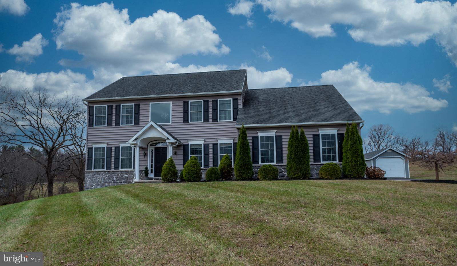 a front view of a house with a garden