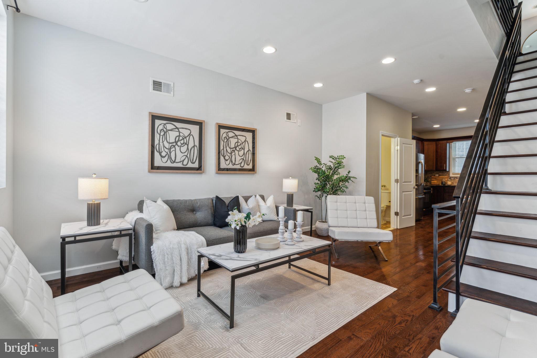 a living room with furniture and wooden floor