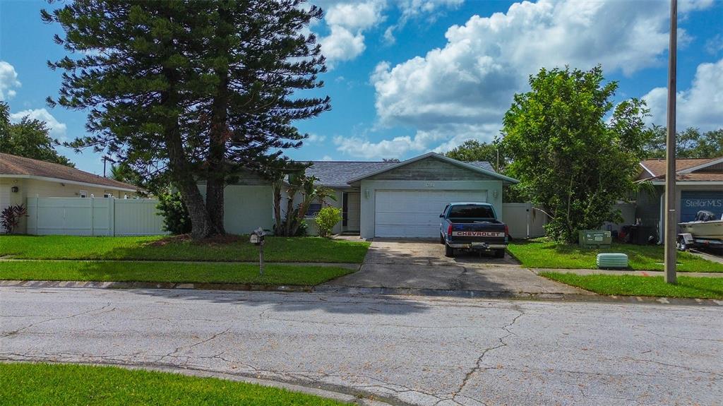 a view of a house with a yard and tree s