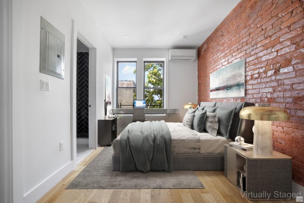 a bedroom with furniture and a large window