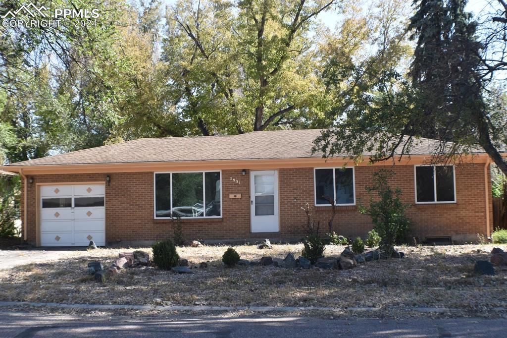 a house that has a tree in front of it