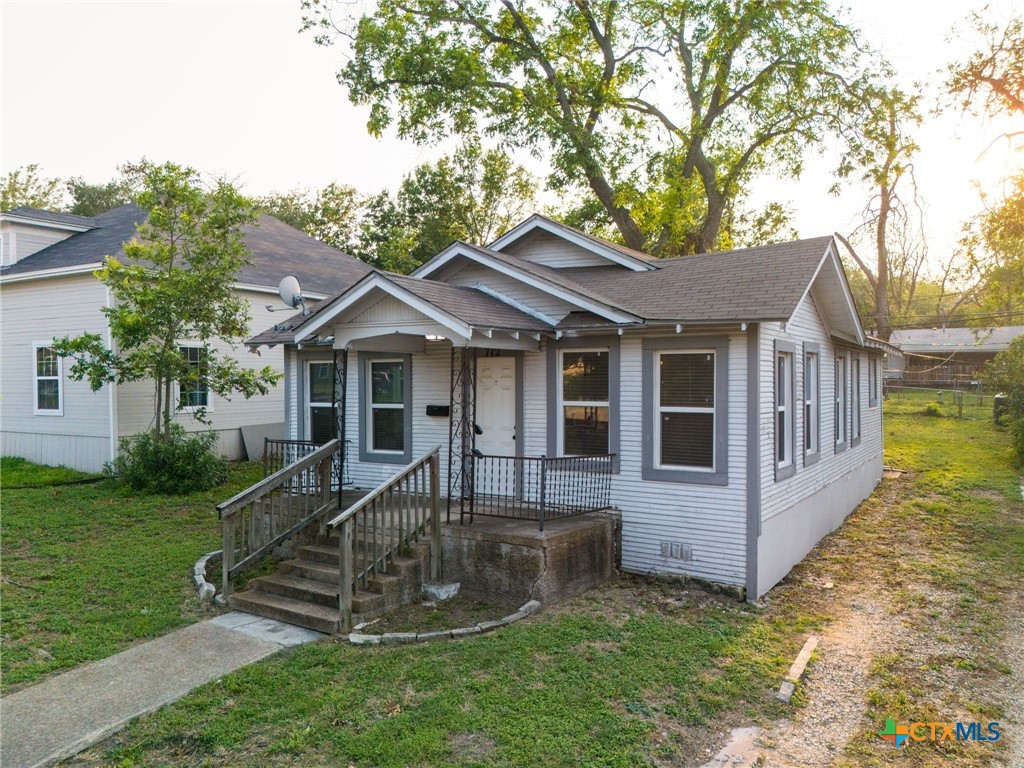 a front view of a house with a yard table and chairs