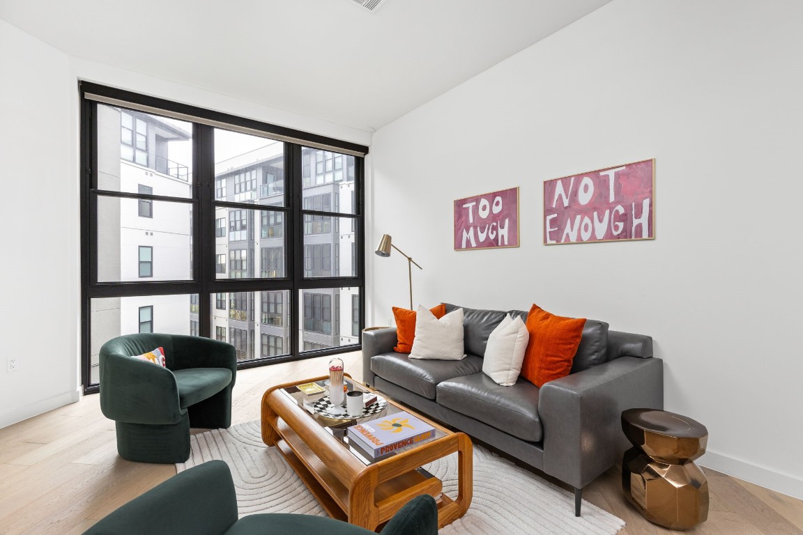 a living room with furniture and a floor to ceiling window