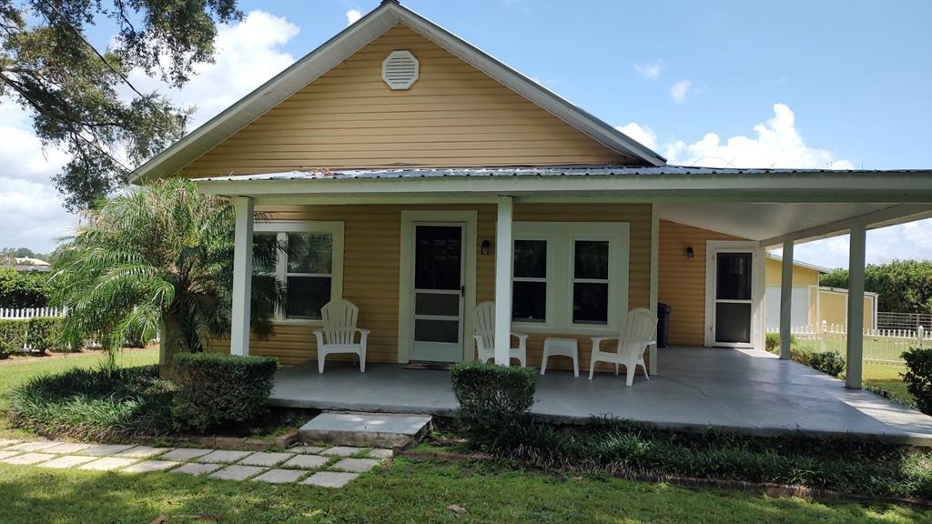 a front view of a house with porch and garden