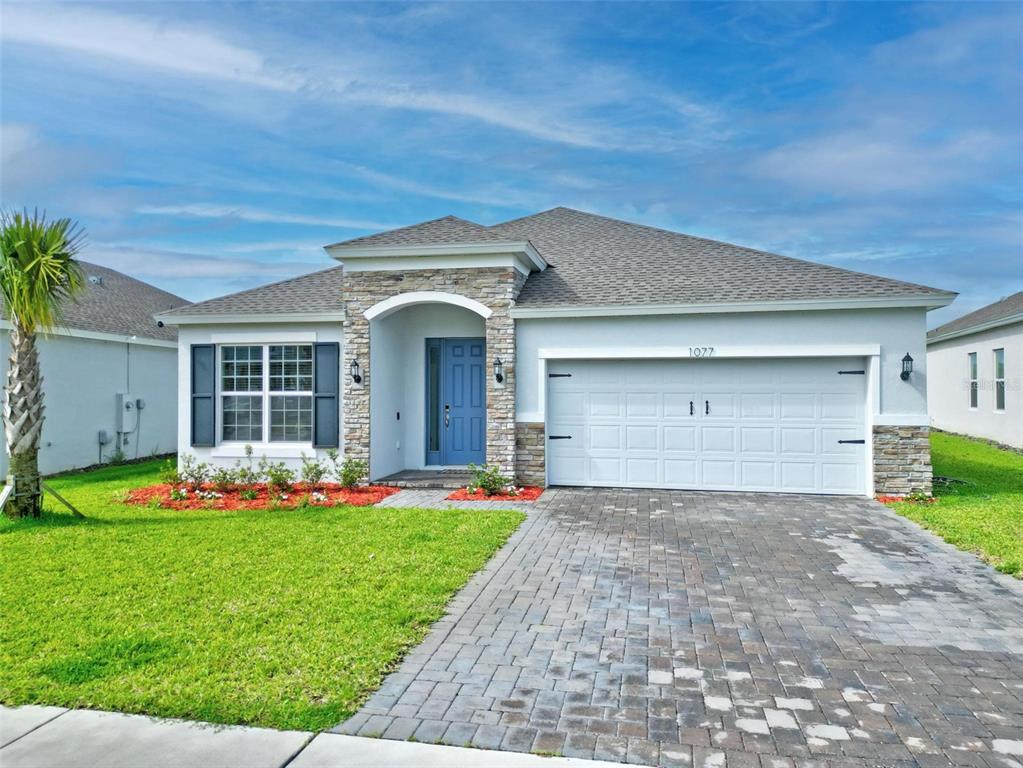 a front view of a house with a yard and garage