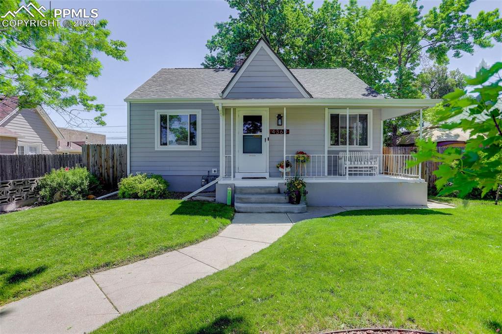 Bungalow-style home with a porch and a front yard