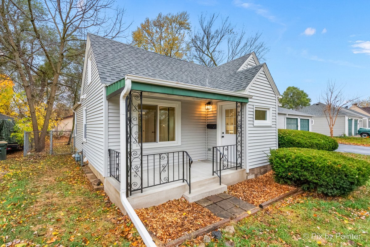 a view of a house with wooden fence