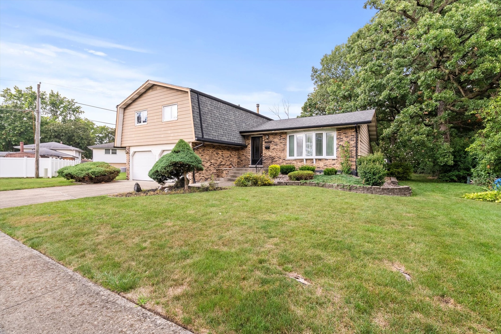 a front view of house with yard and green space