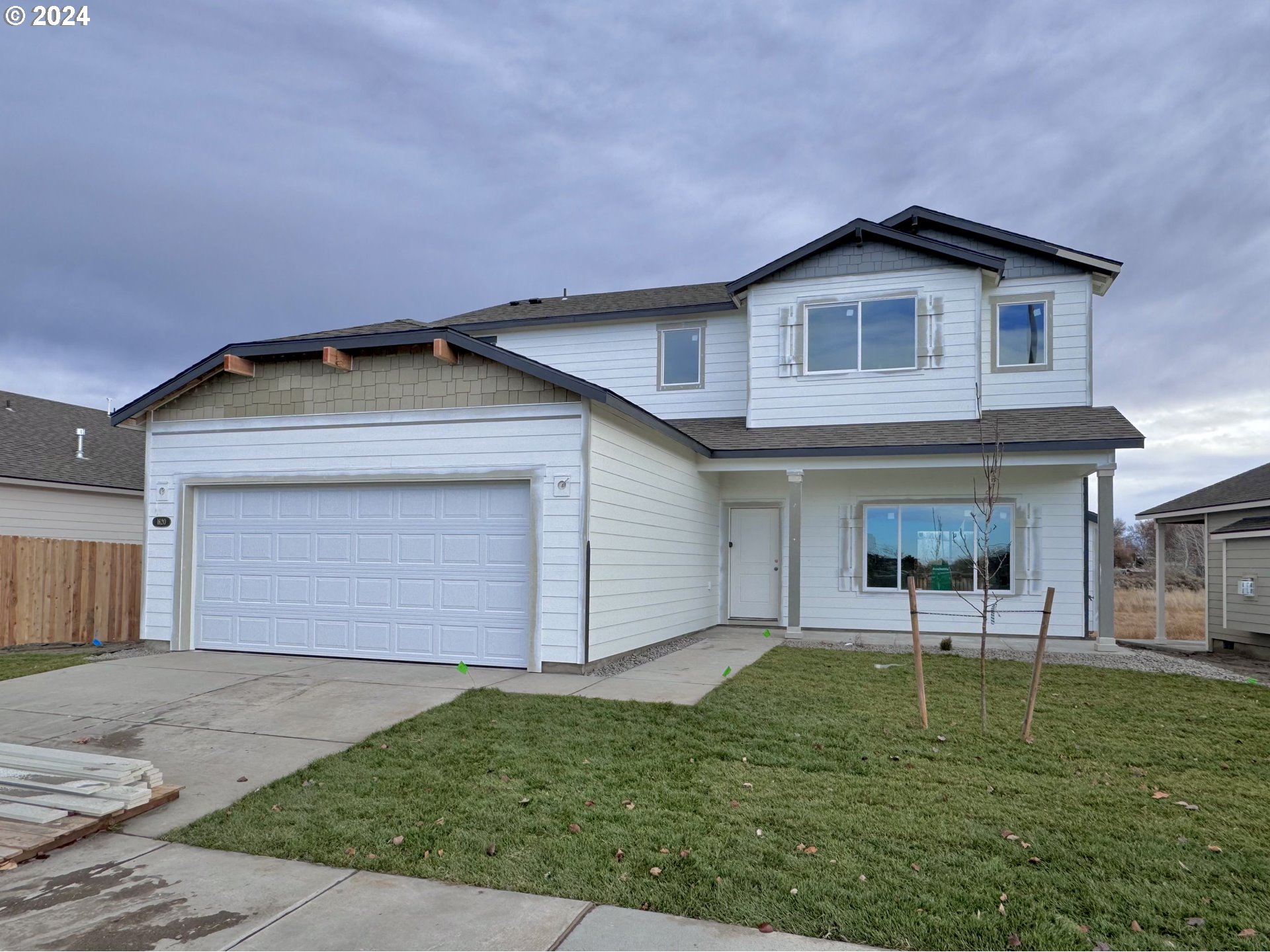 a view of a house with a yard and garage