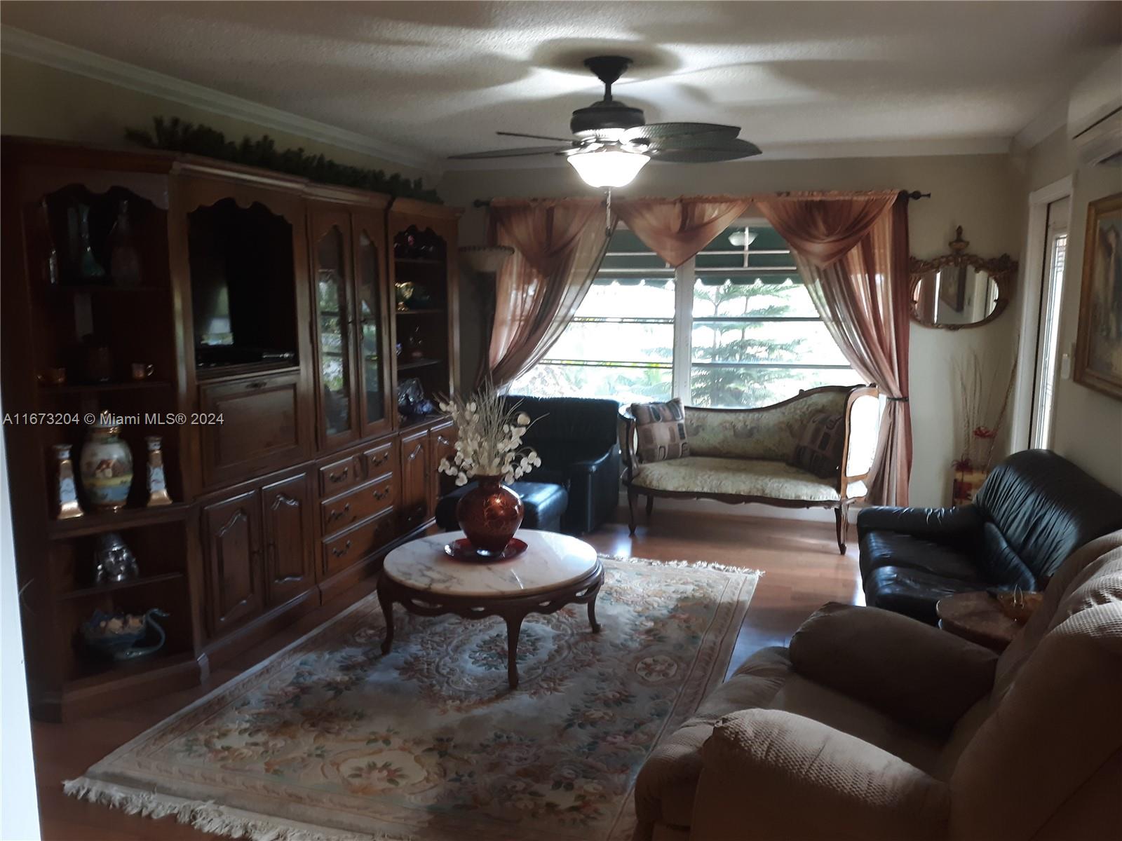 a living room with furniture a window and a chandelier