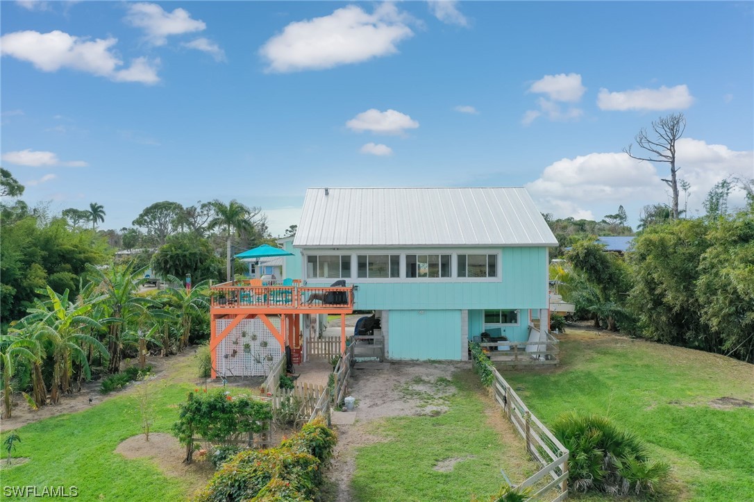 an aerial view of a house with swimming pool table and chairs