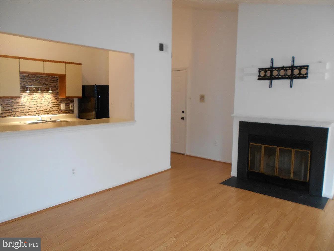 a view of empty room with furniture and fireplace