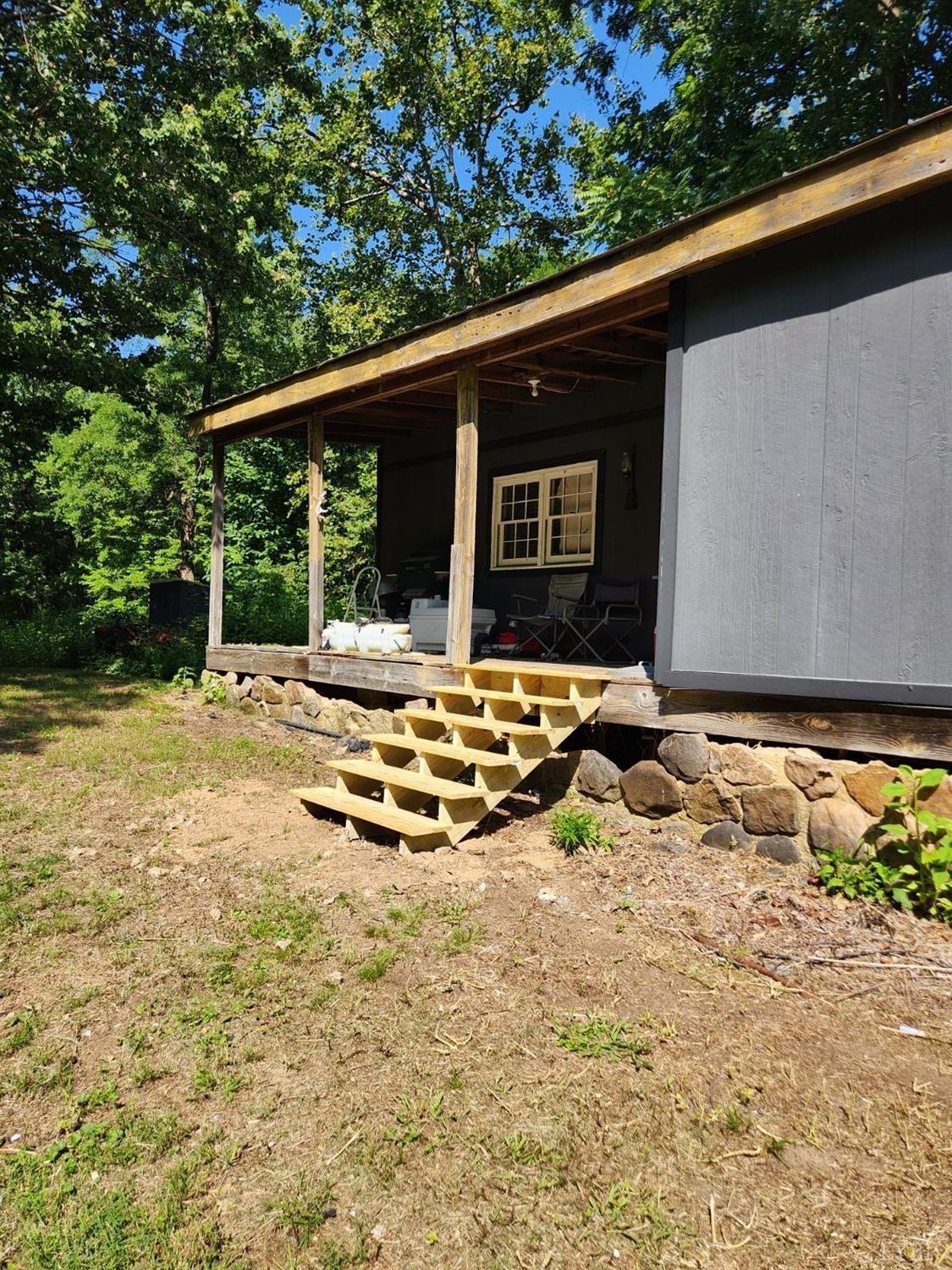 a view of a backyard with table and chairs under an umbrella