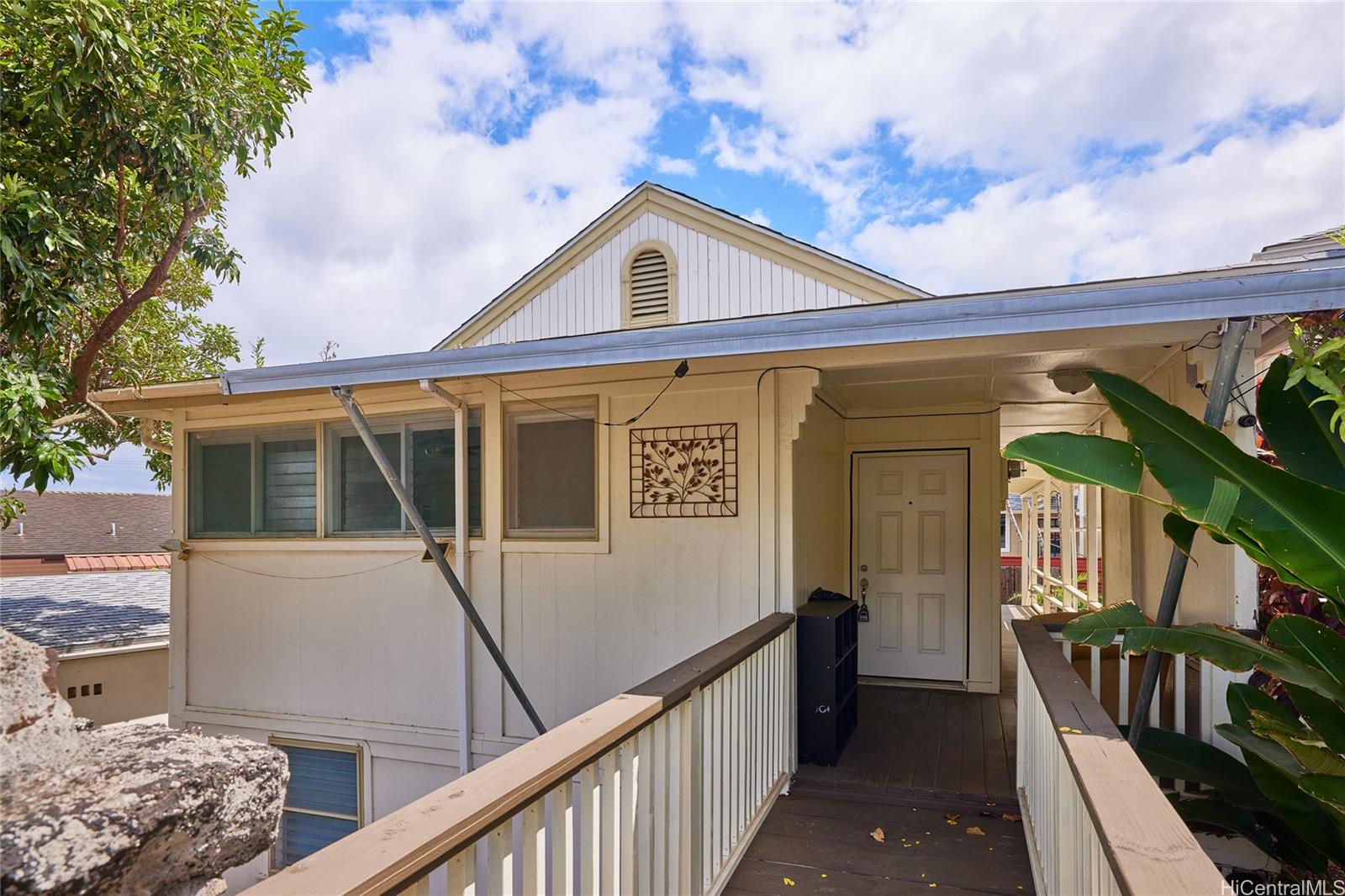 a view of a house with wooden fence