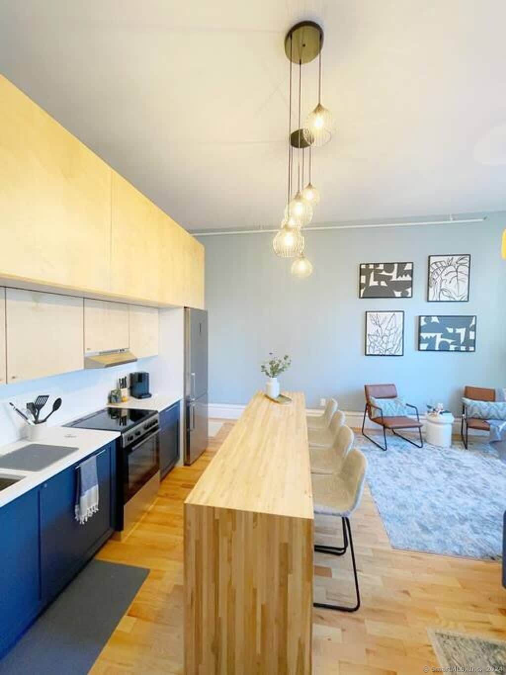 a kitchen with a table chairs and refrigerator