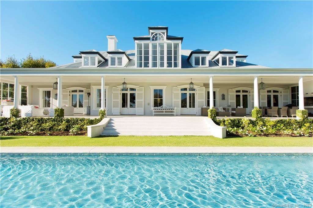 a view of a house with swimming pool and a yard