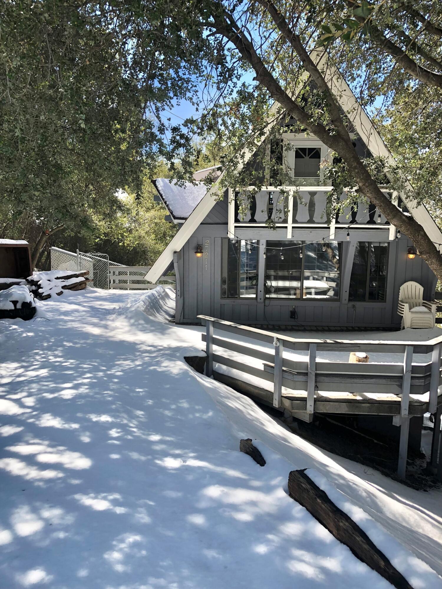 a view of a house with a large tree