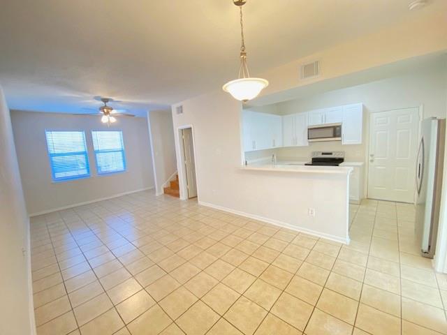 a view of a kitchen with a sink and a refrigerator