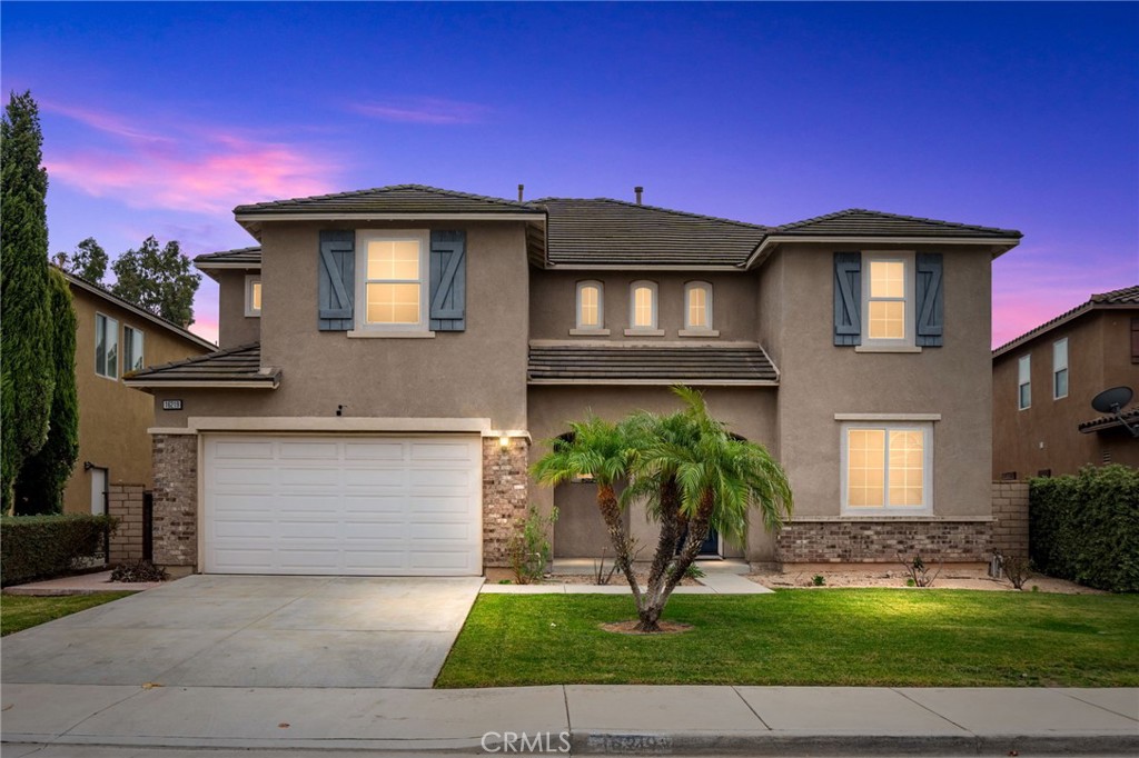 a front view of a house with a yard and garage