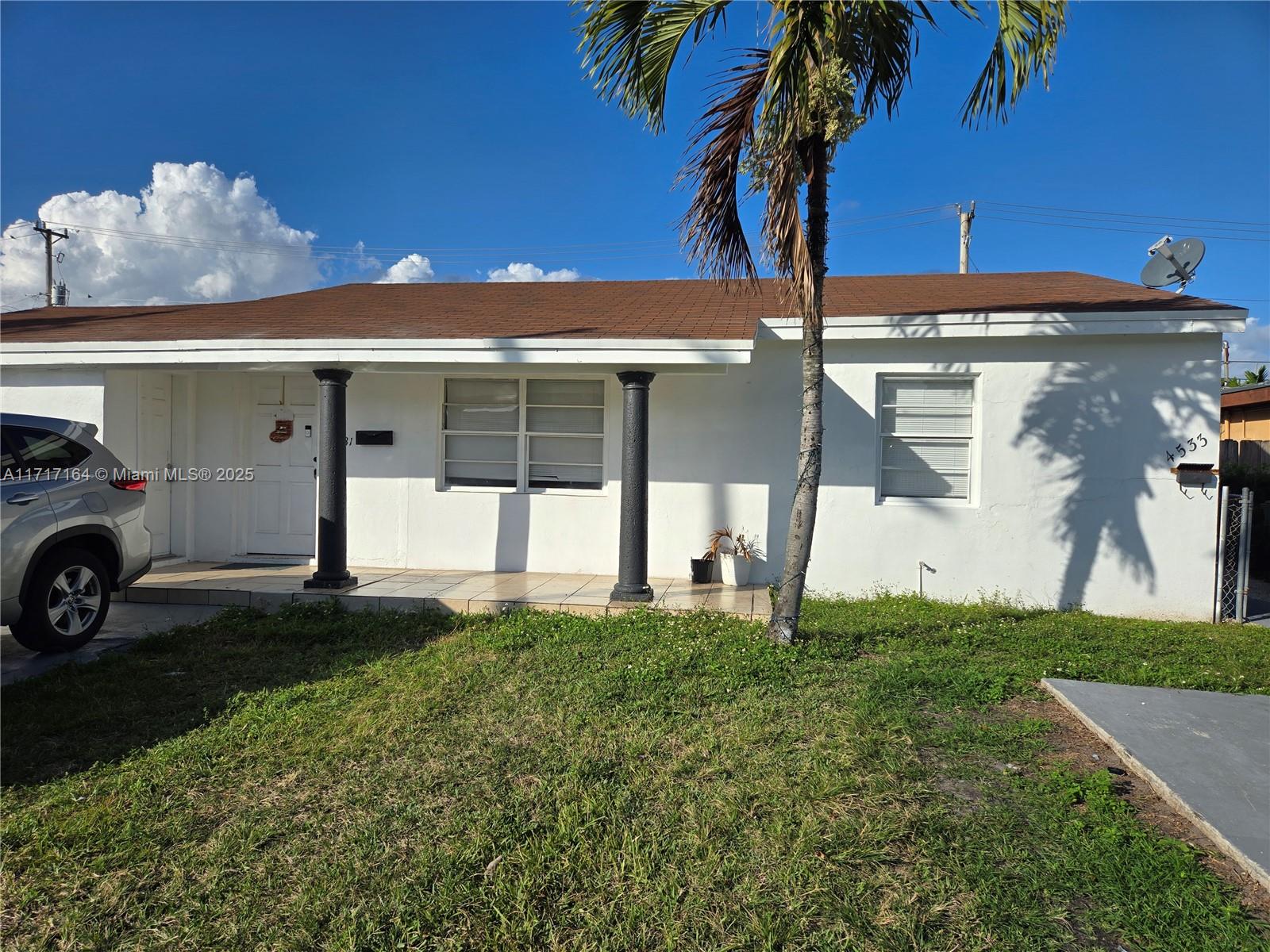 a view of a house with a yard and garage