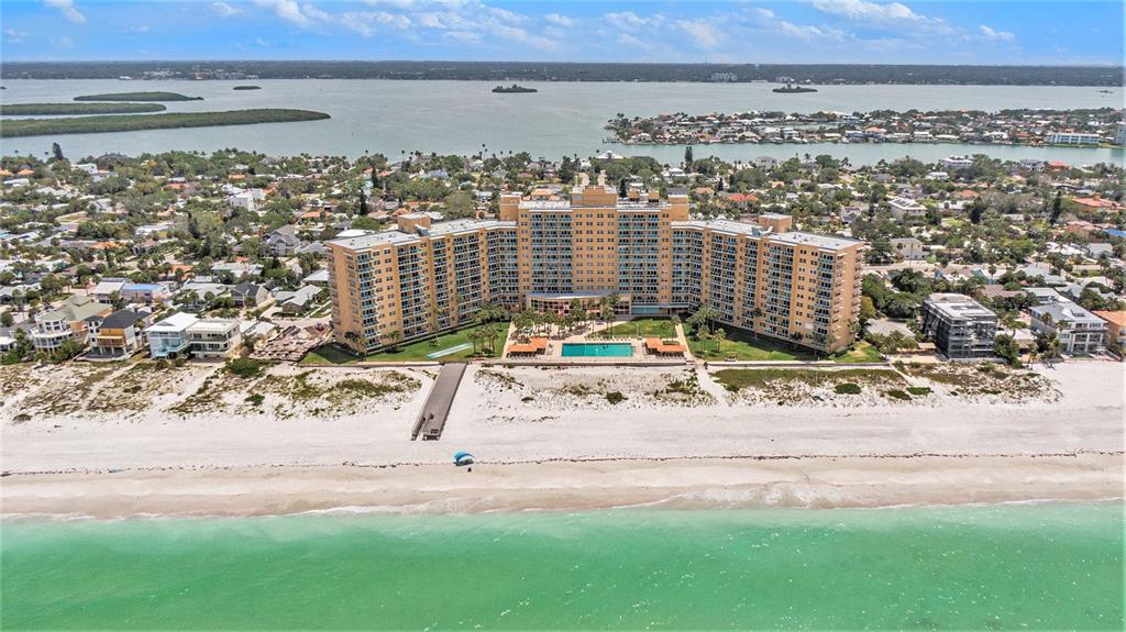 an aerial view of residential building and ocean view