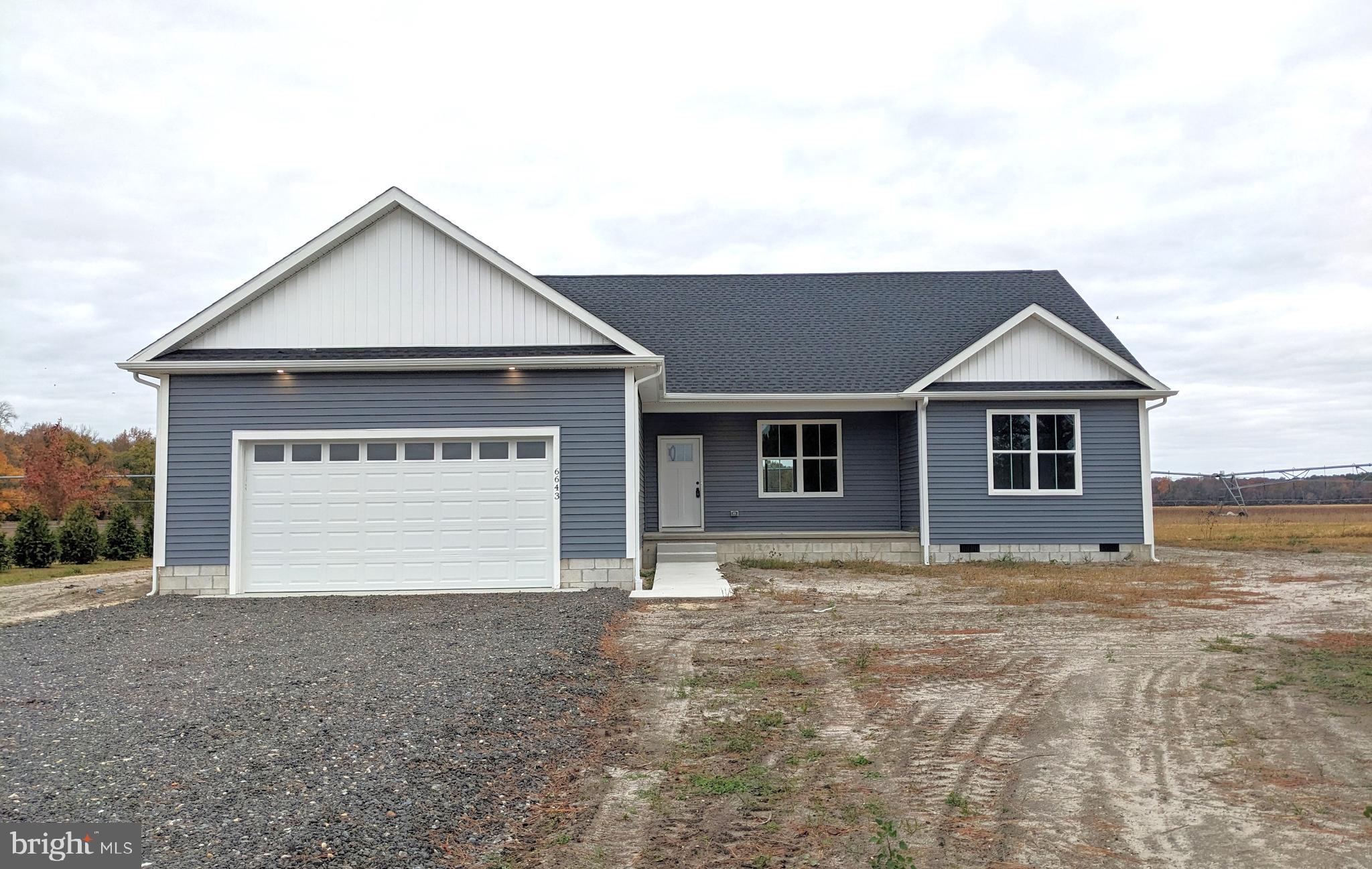 a view of an house with backyard space and garage