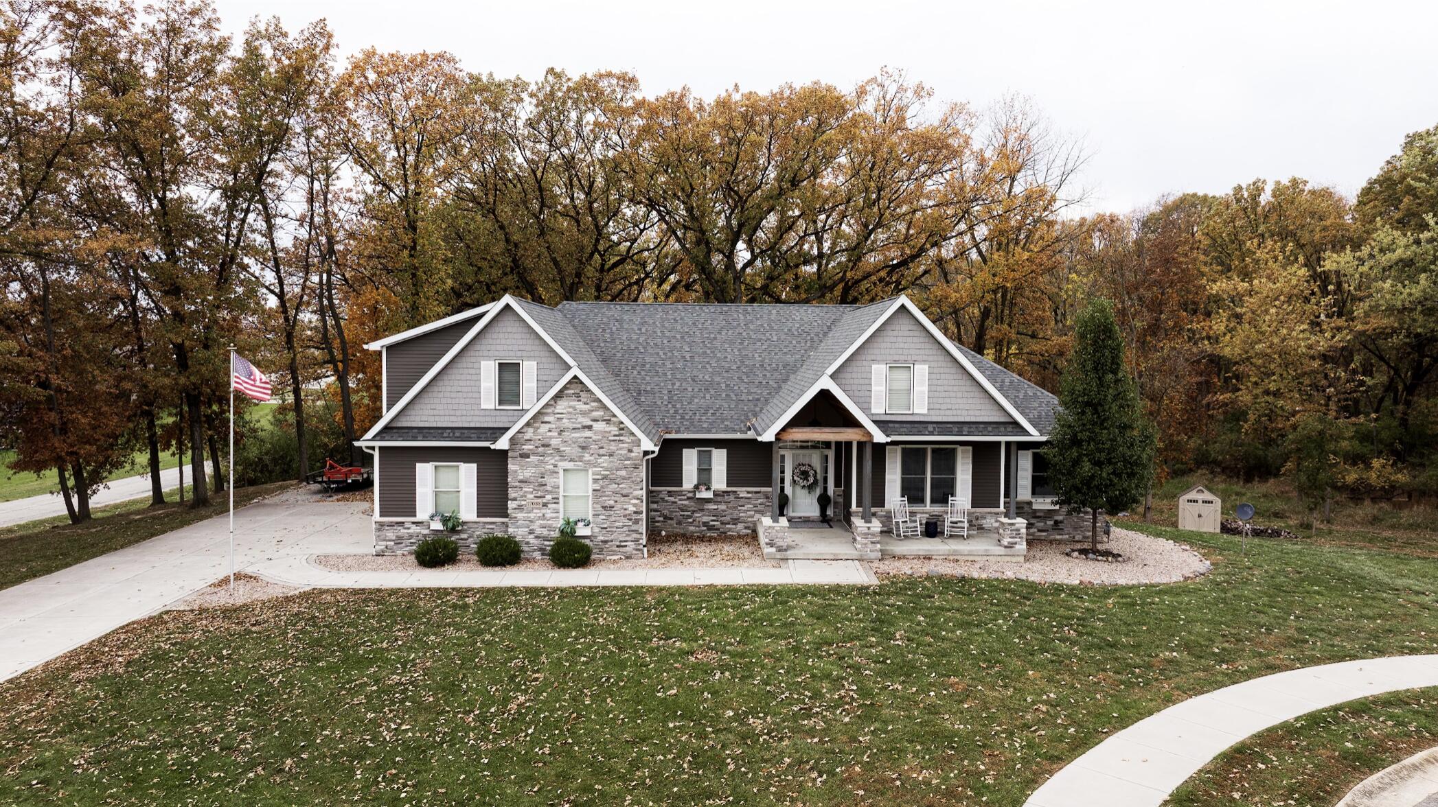 a front view of a house with yard and green space