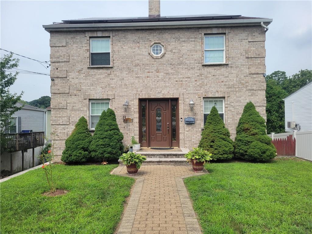 a front view of a house with a yard