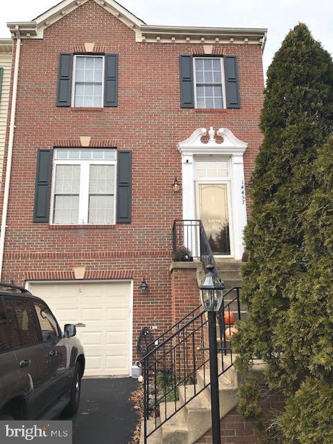 a front view of a house with parking space