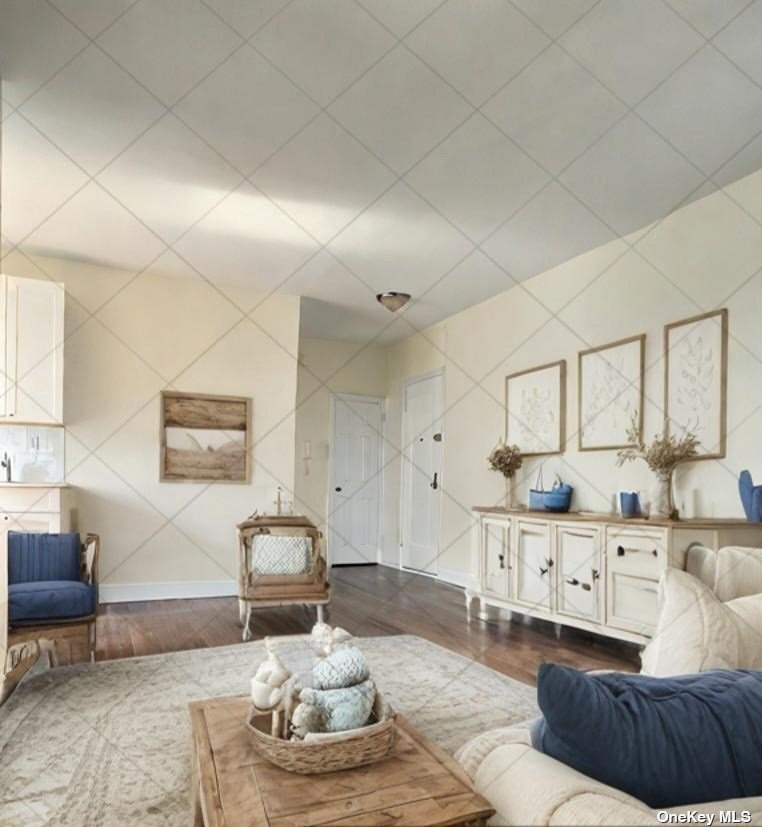 a living room with furniture and kitchen view