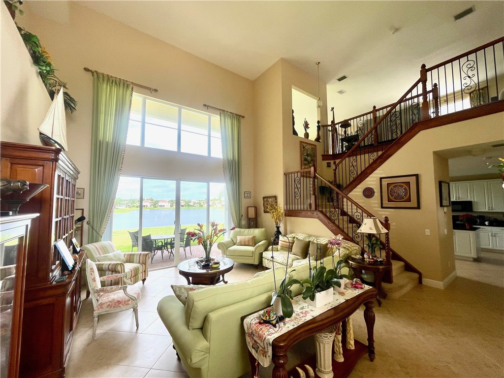 a living room with furniture fireplace and a large window