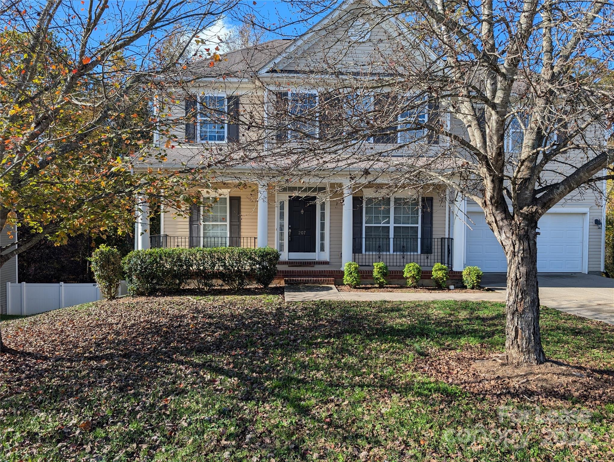 a front view of a house with yard and green space