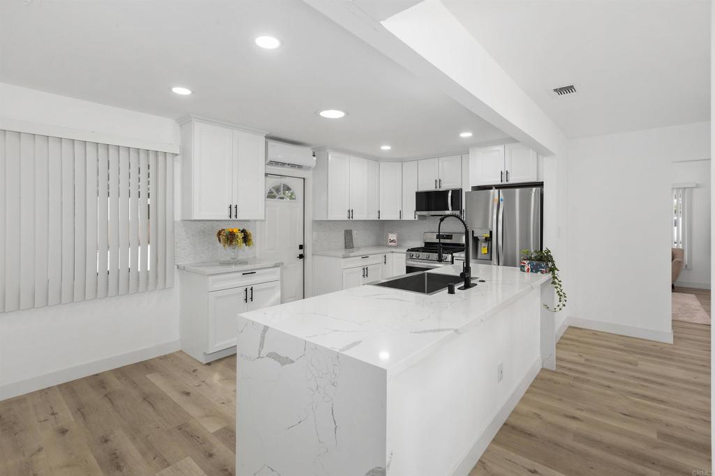 a kitchen with stainless steel appliances a refrigerator sink and cabinets