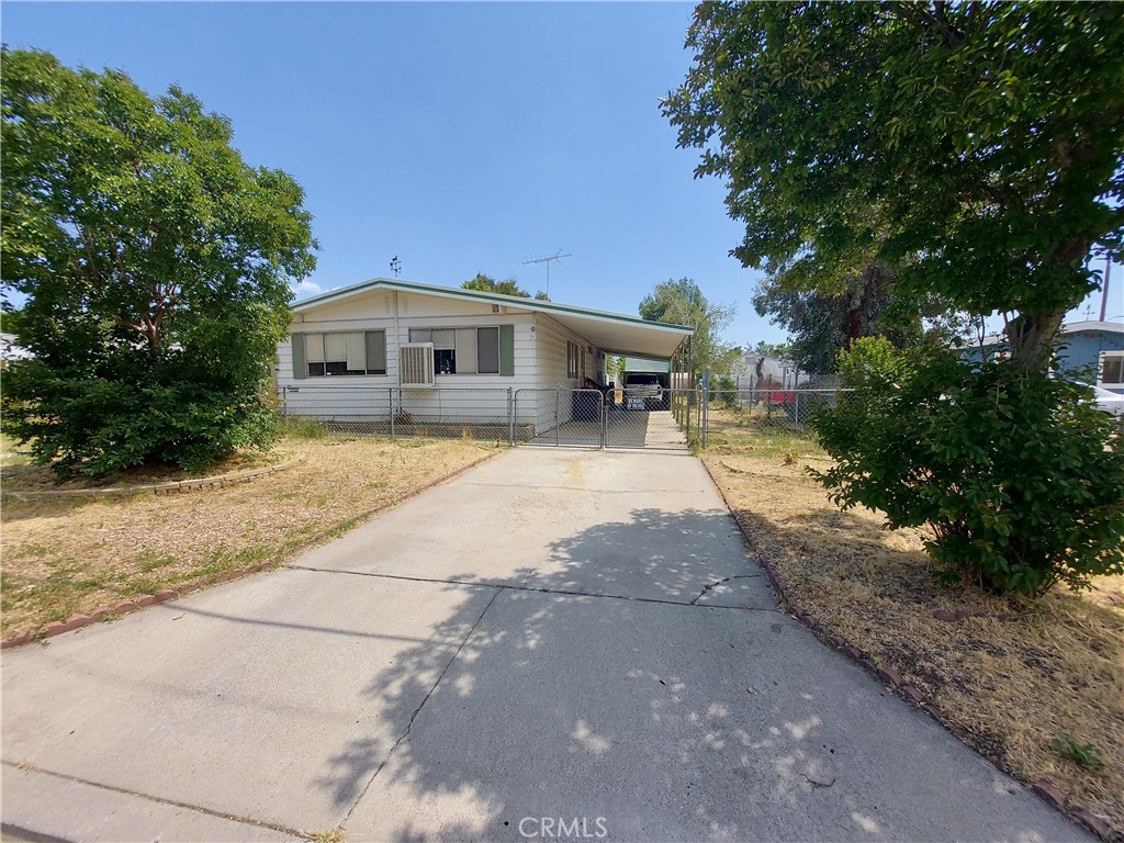 a front view of a house with yard and trees