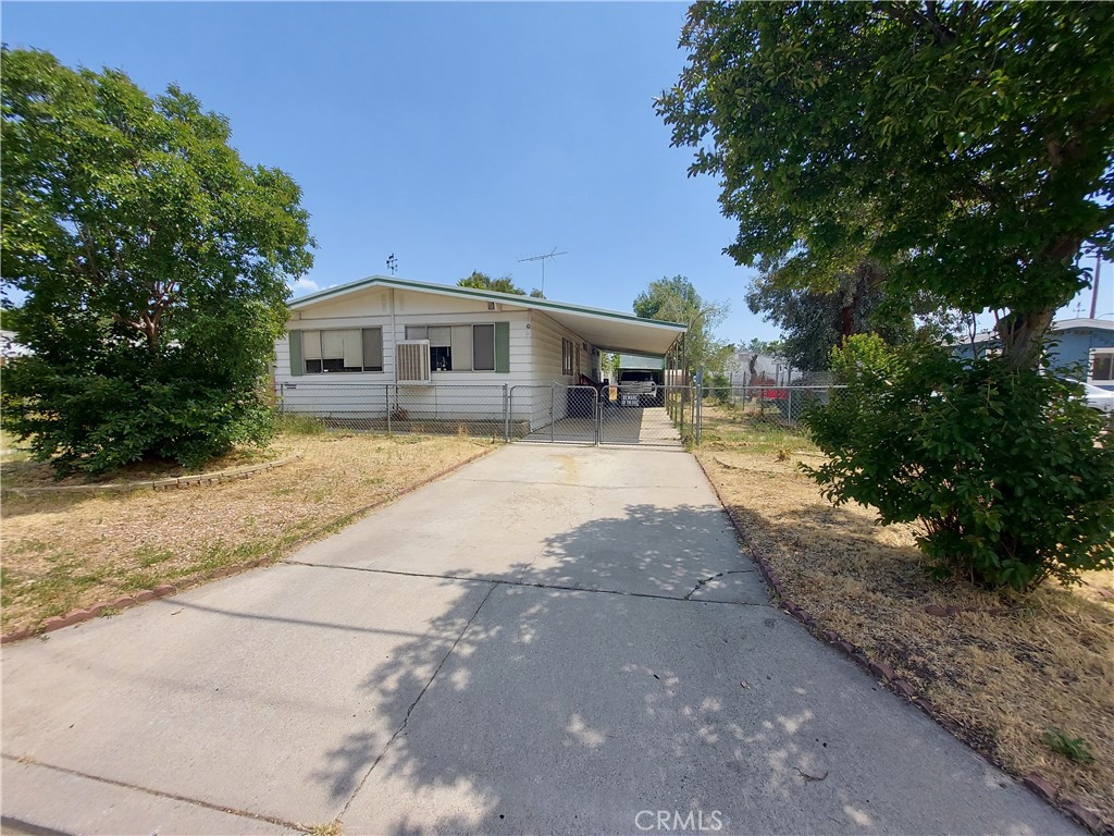 a front view of a house with yard and trees