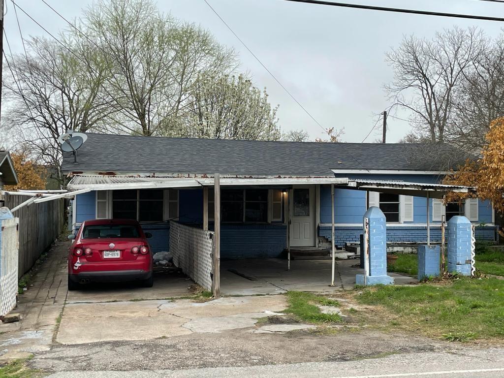 a view of a car parked in front of a house